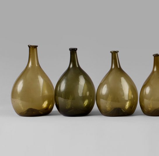 An Exceptional Set of 13 Graduated Blown Chestnut Bottles